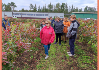 Owner of company “Arosa-R” Ltd. in front and participants of Field day in blueberries field