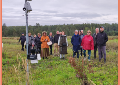 Participants of Field day near ATLAS meteorological station in blueberries plantation listening about data transfer, importance and possible use of environment data.